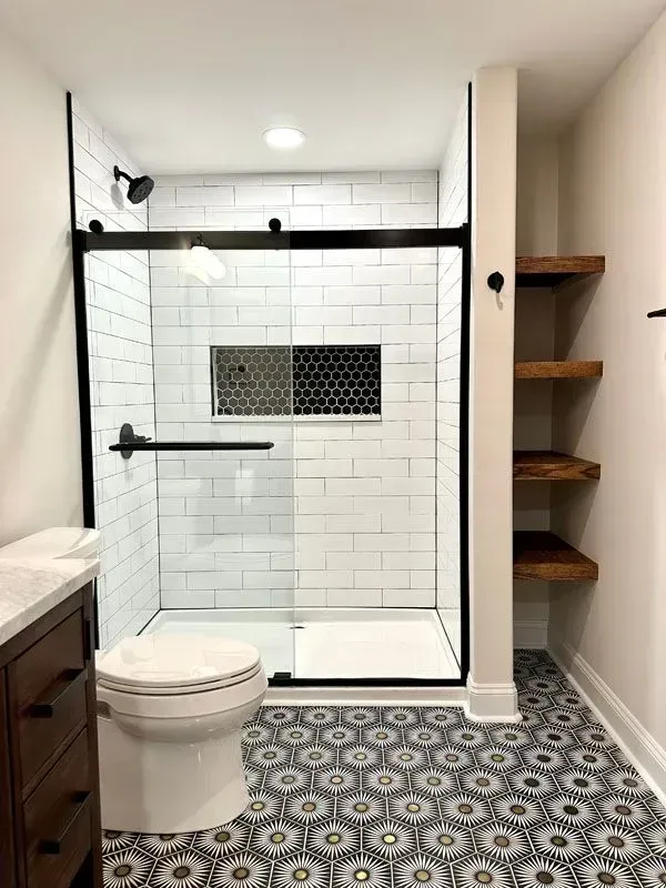 A bathroom with a toilet , sink , and shower.