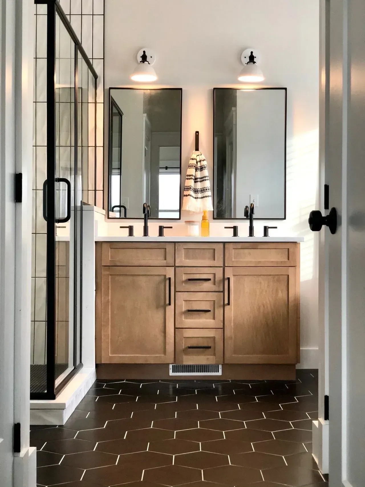 A bathroom with two sinks and two mirrors