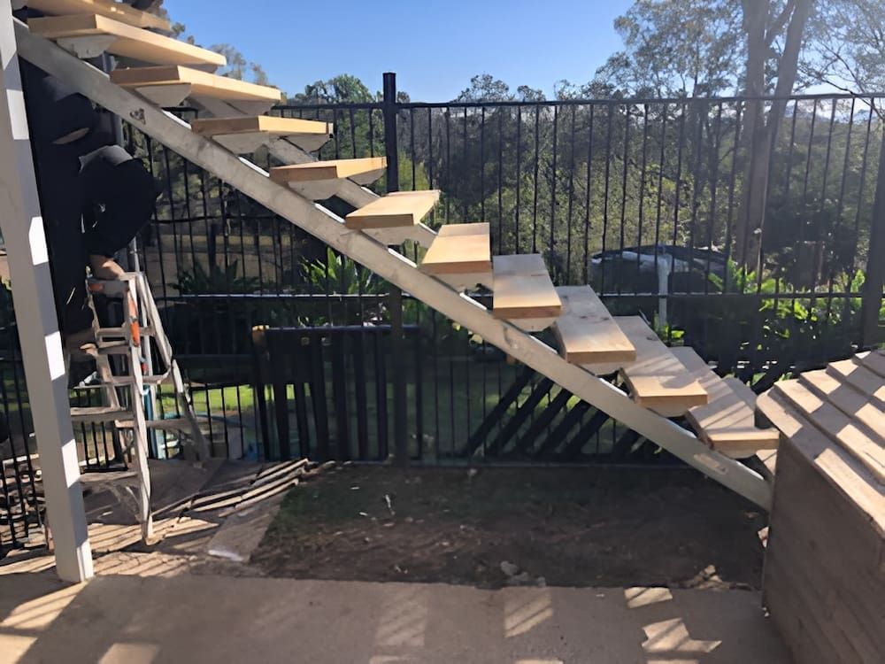 Staircase Under Construction With Wooden Steps and Metal Frame — Alcando Renovations and Maintenance in Bobin, NSW
