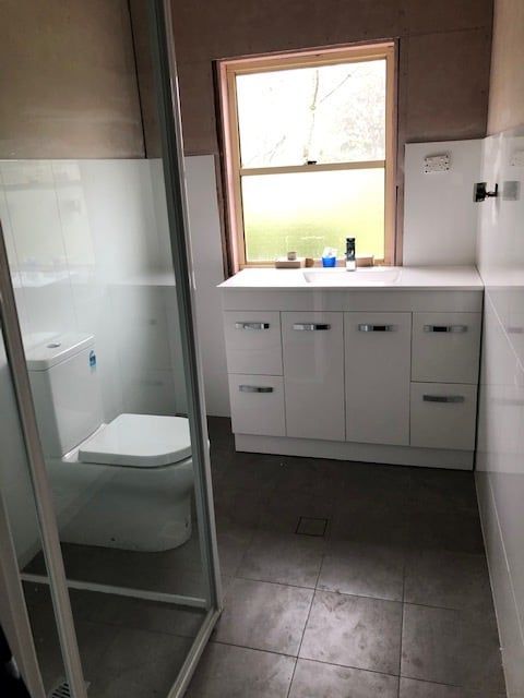 Bathroom With White Vanity, Toilet, and Shower — Alcando Renovations and Maintenance In Old Bar, NSW