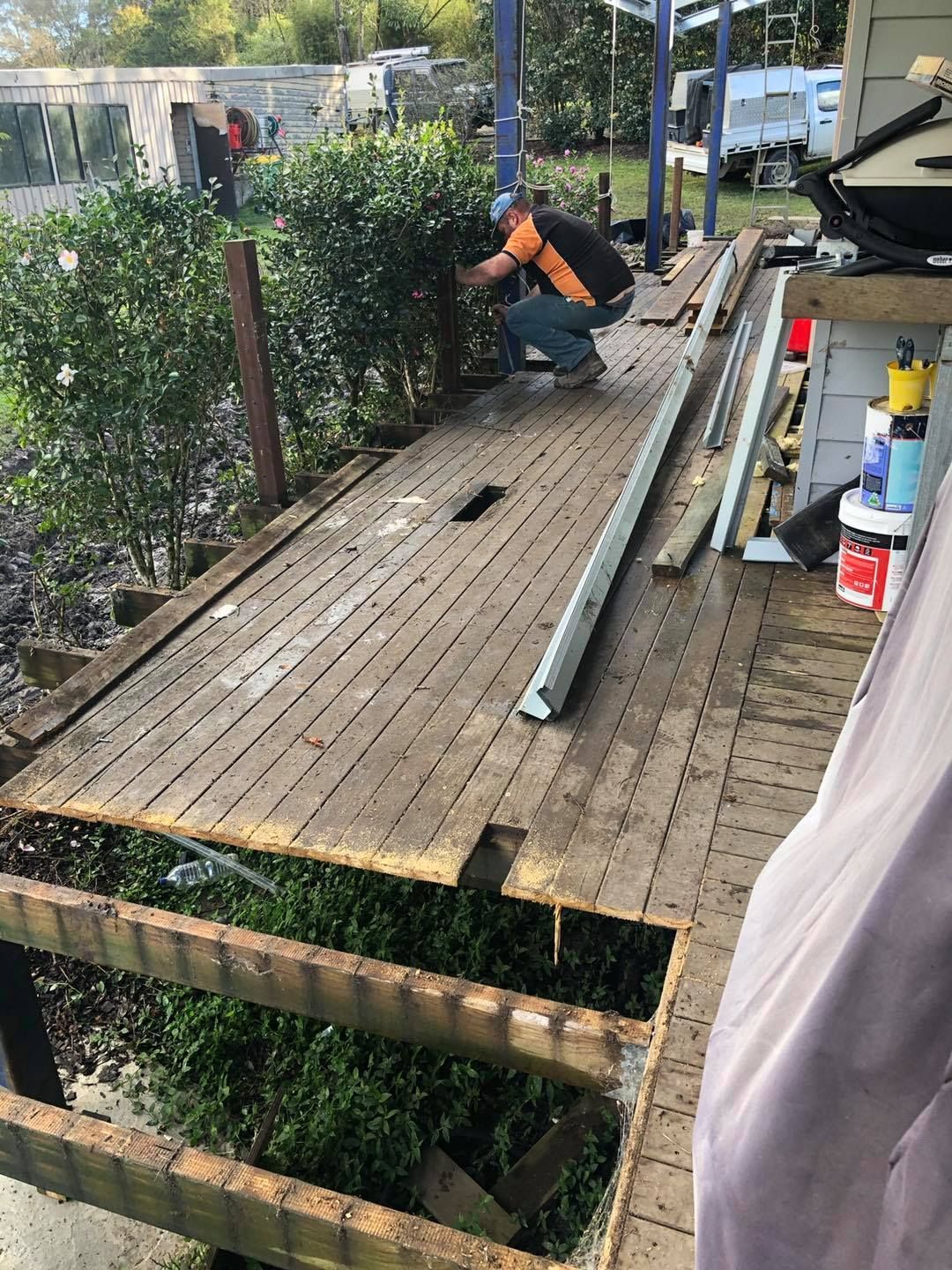 Person Repairs Damaged Wooden Deck Outdoors — Alcando Renovations and Maintenance In Taree, NSW