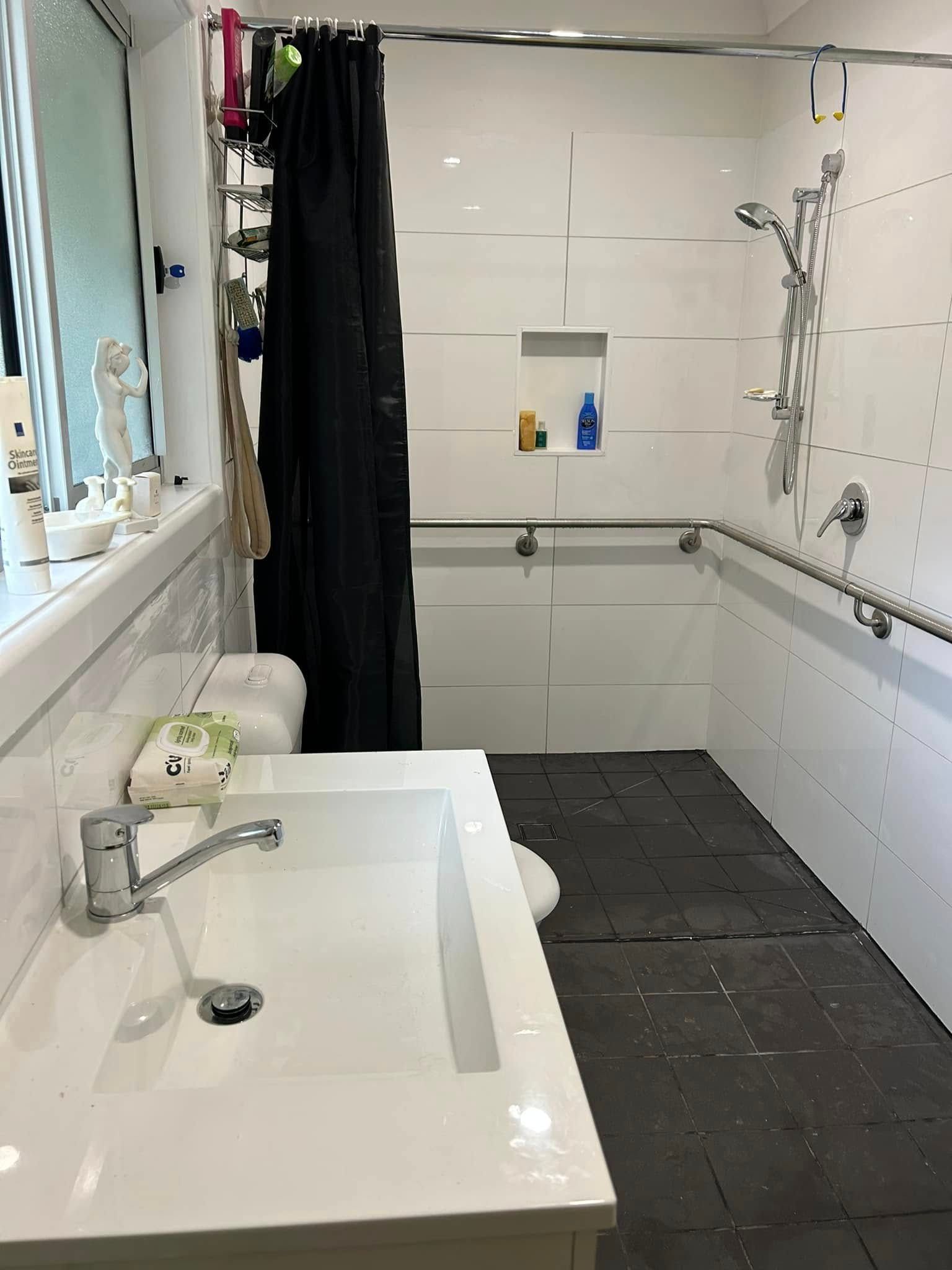 Bathroom With White Tiles, Sink, and Shower — Alcando Renovations and Maintenance In Bobin, NSW