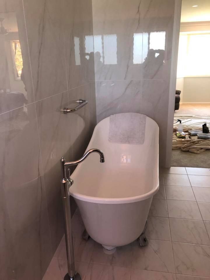 Clawfoot Bathtub With Chrome Faucet Against Marble Tiled Walls — Alcando Renovations and Maintenance In Bobin, NSW