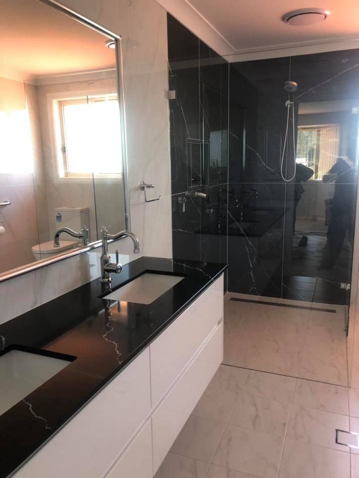 Modern Bathroom With Black Marble Shower and Vanity — Alcando Renovations and Maintenance In Old Bar, NSW