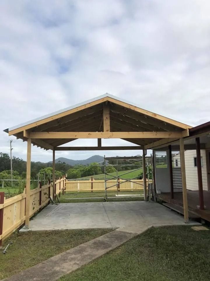 Carport With a Wooden Frame and Metal Roof Over a Concrete Driveway — Alcando Renovations and Maintenance In Bobin, NSW
