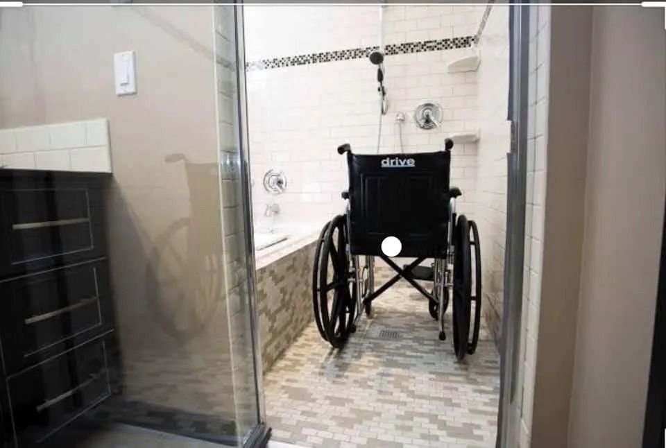 Wheelchair in Accessible Shower With Grab Bars and Built-in Bench — Alcando Renovations and Maintenance In Bobin, NSW