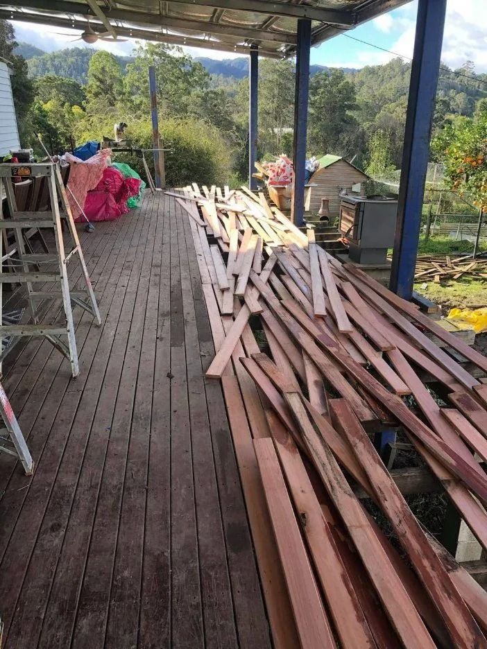 Wood Planks on a Porch. a-frame Ladder, Trees and Mountains — Alcando Renovations and Maintenance In Bobin, NSW