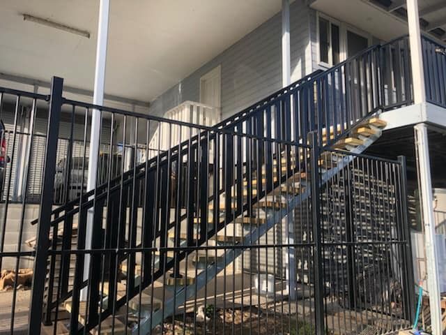 Black Metal Staircase With Railings, Leading to a Second Story — Alcando Renovations and Maintenance In Bobin, NSW