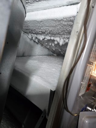 Snow and ice piled on a vehicle window and door frame