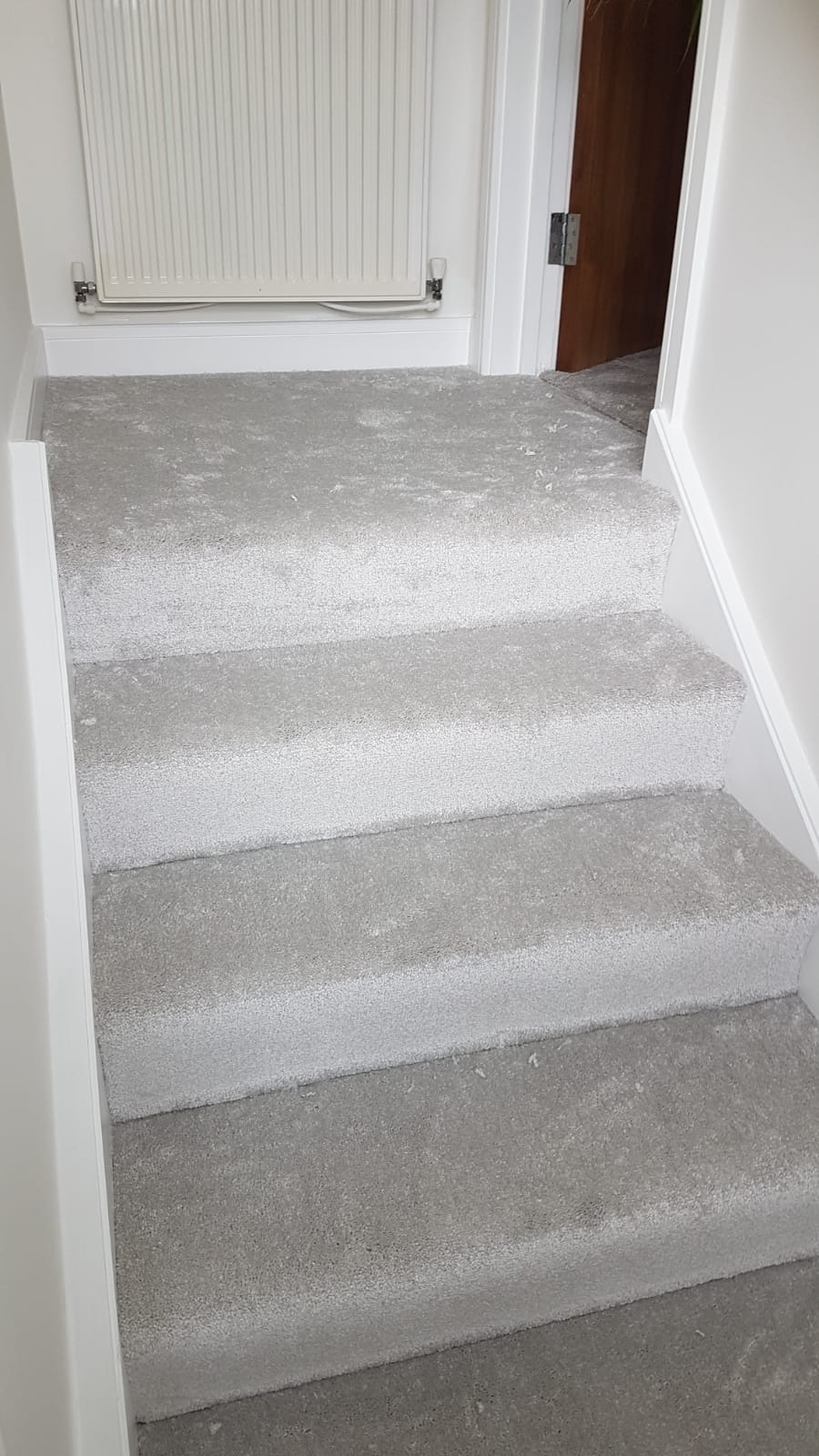 A set of stairs with a carpeted floor in a house.