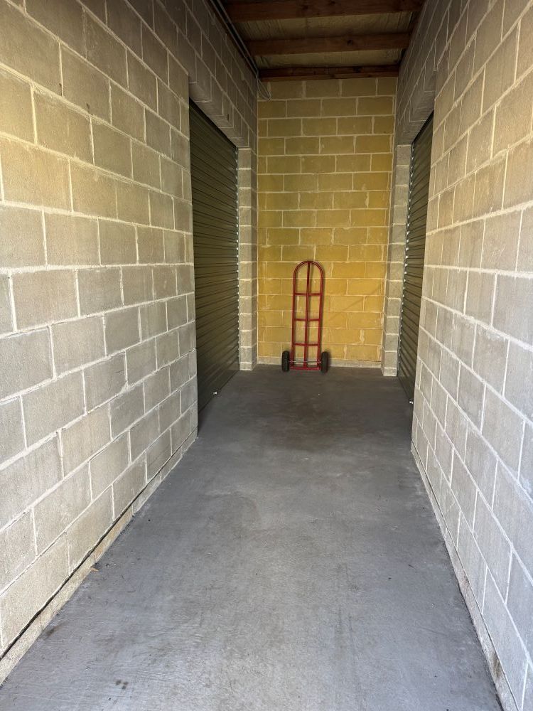 A Brick Hallway With a Hand Truck in the Middle of It — Huskisson Self Storage in Huskisson, NSW
