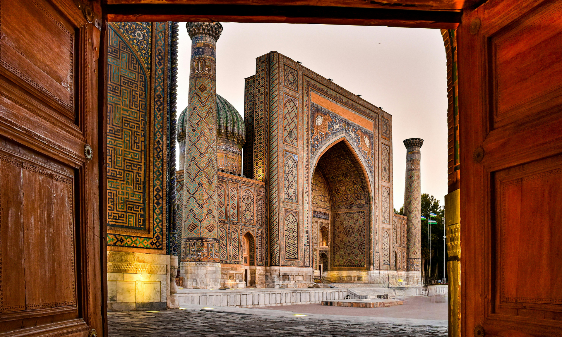 A view of a mosque through a wooden door in samarkland