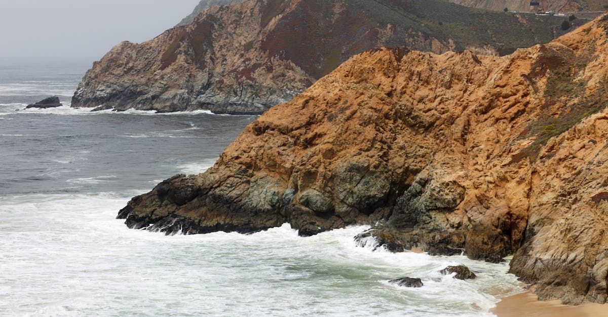 A cliff overlooking the ocean with waves crashing against it