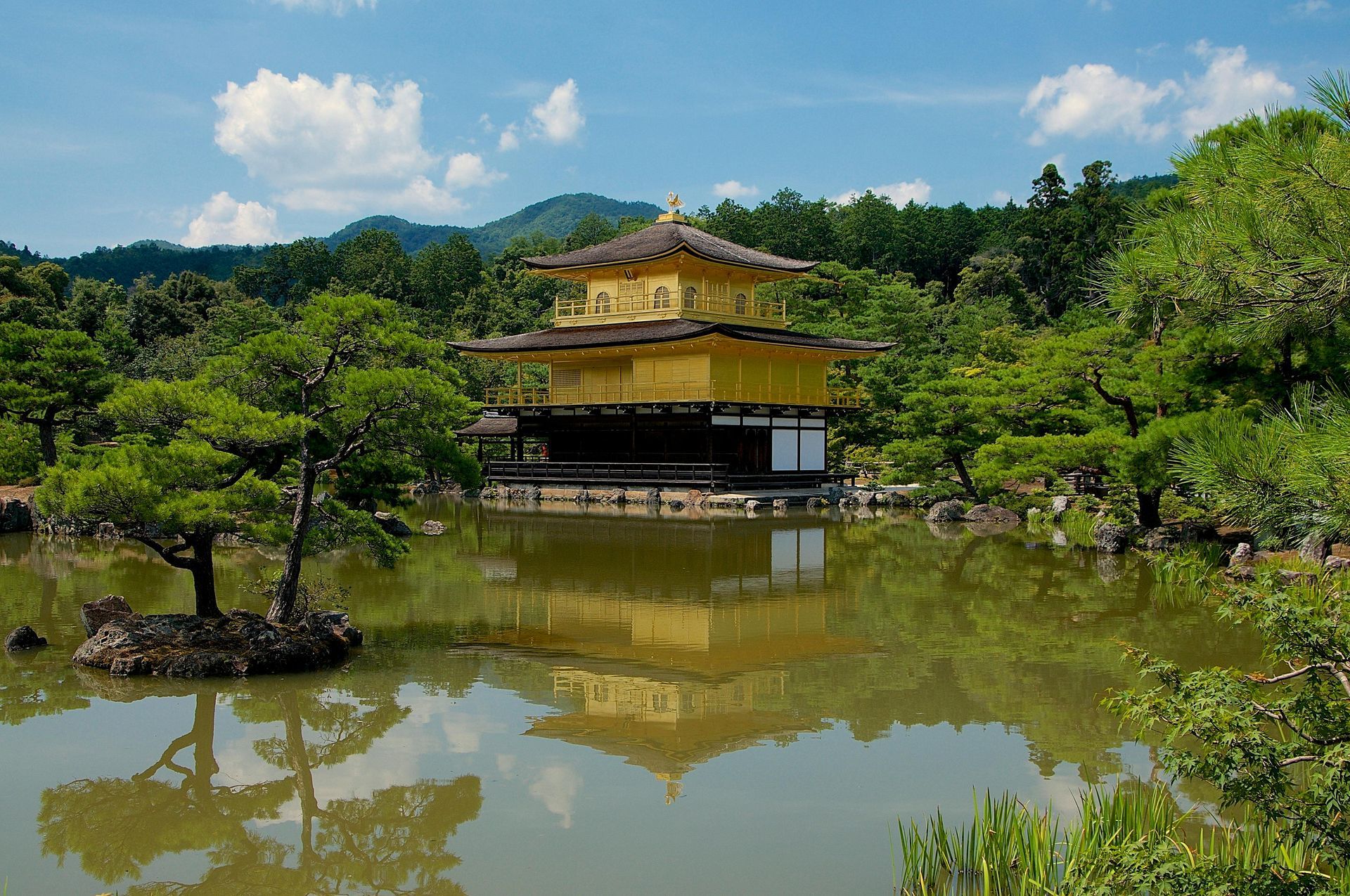 A pagoda with a blue sky and white clouds in the background