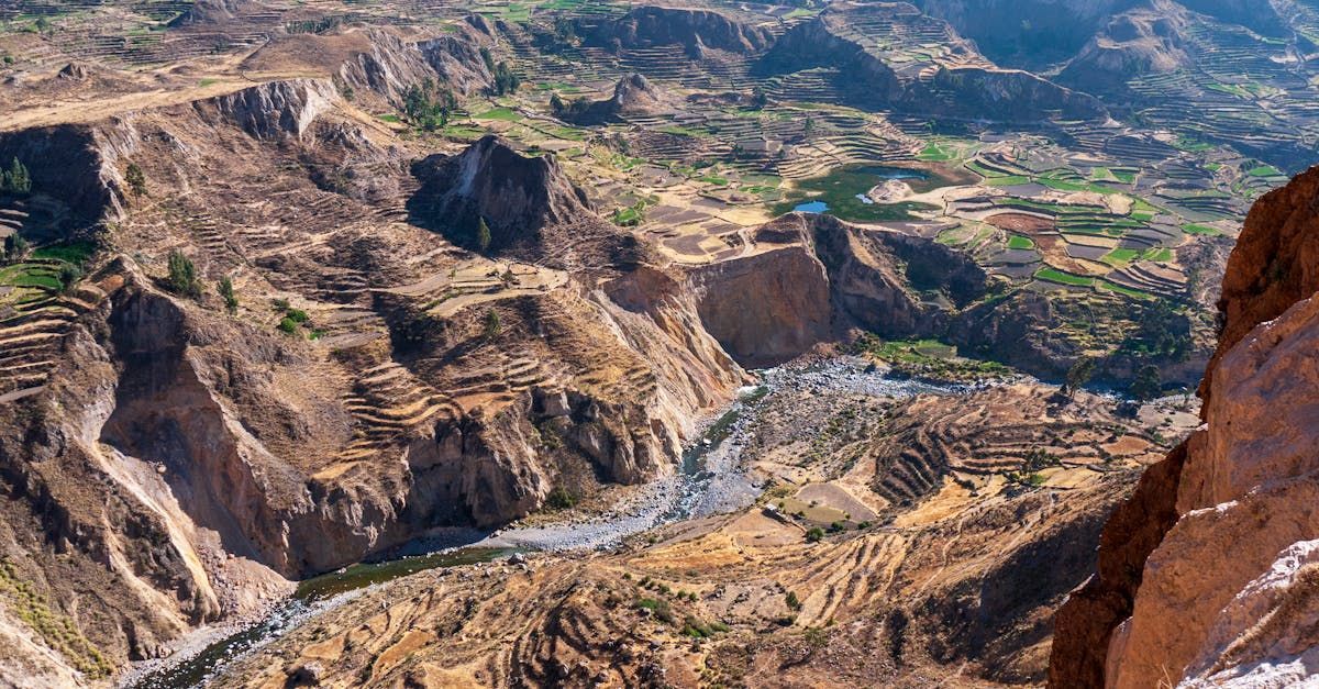 An aerial view of a canyon with a river running through it.