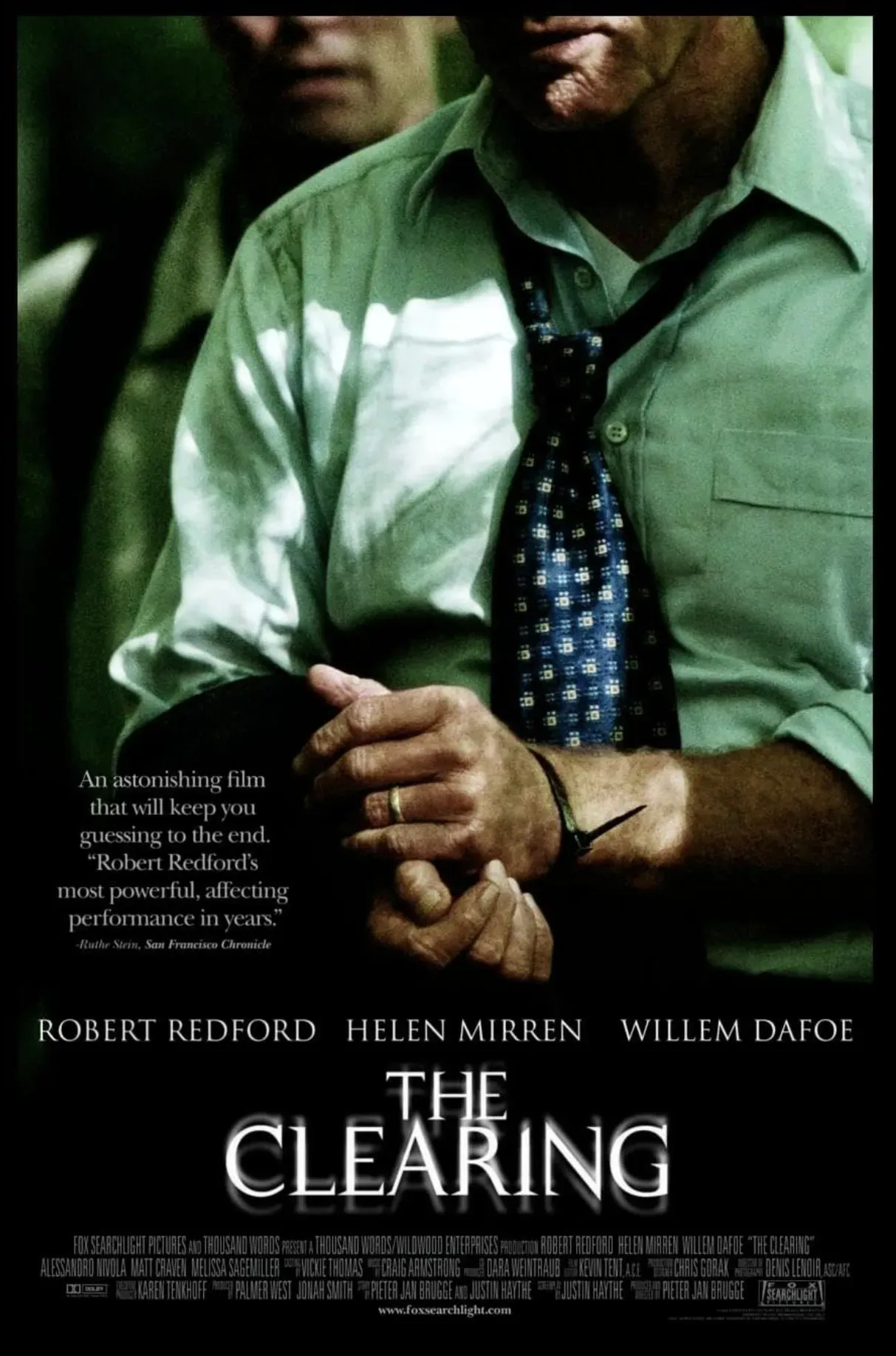 Movie poster for The Clearing, showing a man in a white shirt and tie holding a cuffed hand.