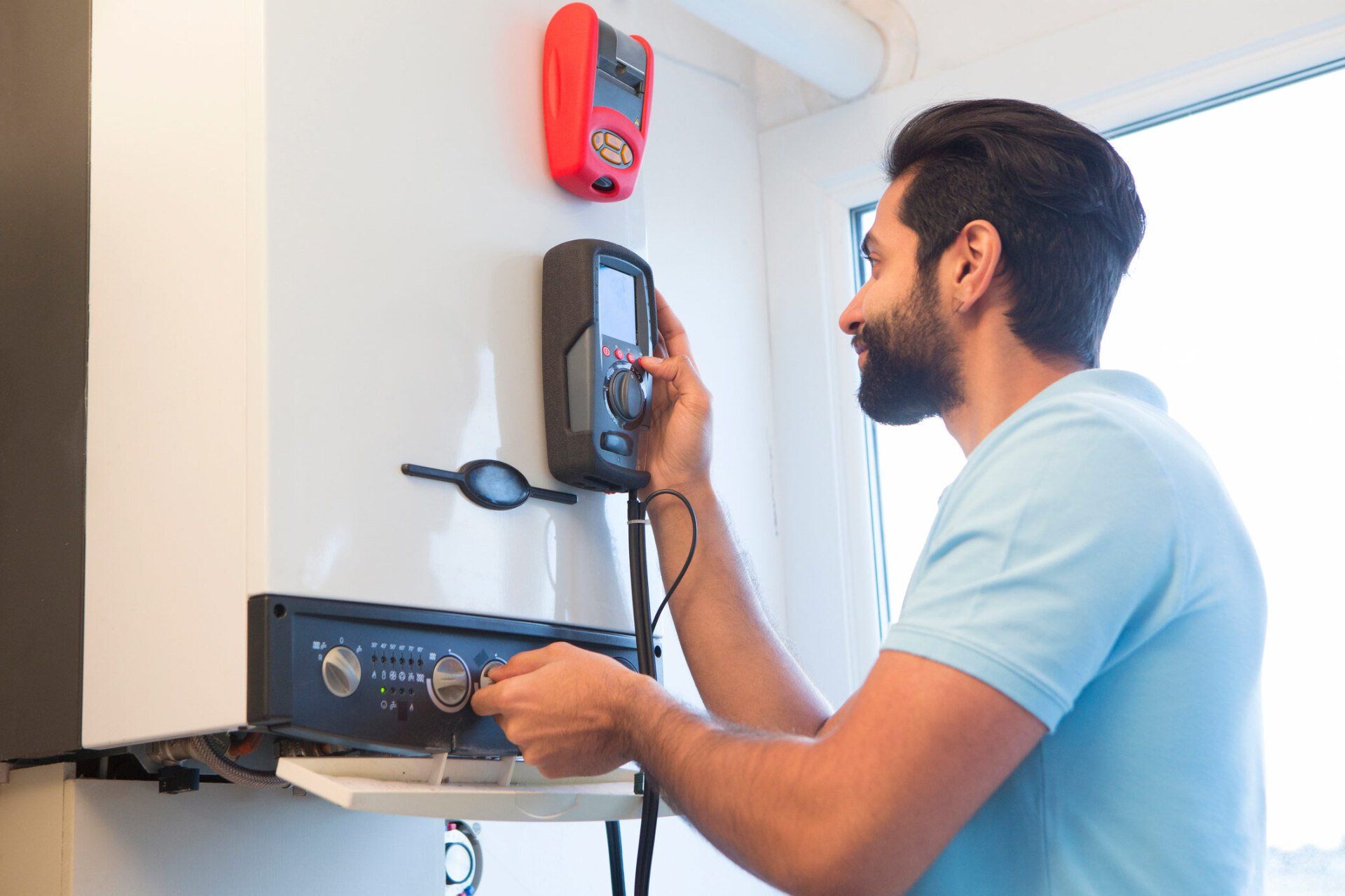 Working On The Water Heater — Burlington, NC — Associated Plumbing Company