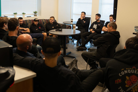 Ad Truck Services - Semi repair employees - Farview, OR - black uniforms seated in a meeting room, listening in a circle.