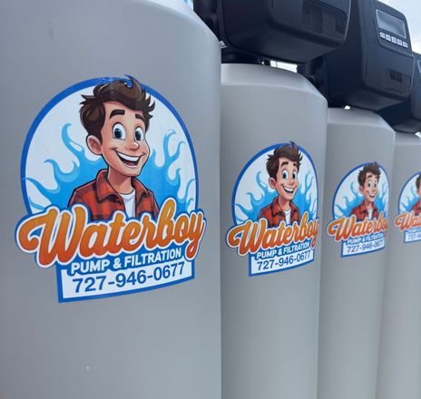WaterBoy Plumbing stickers on gray equipment tanks, with a smiling cartoon plumber logo and phone number.