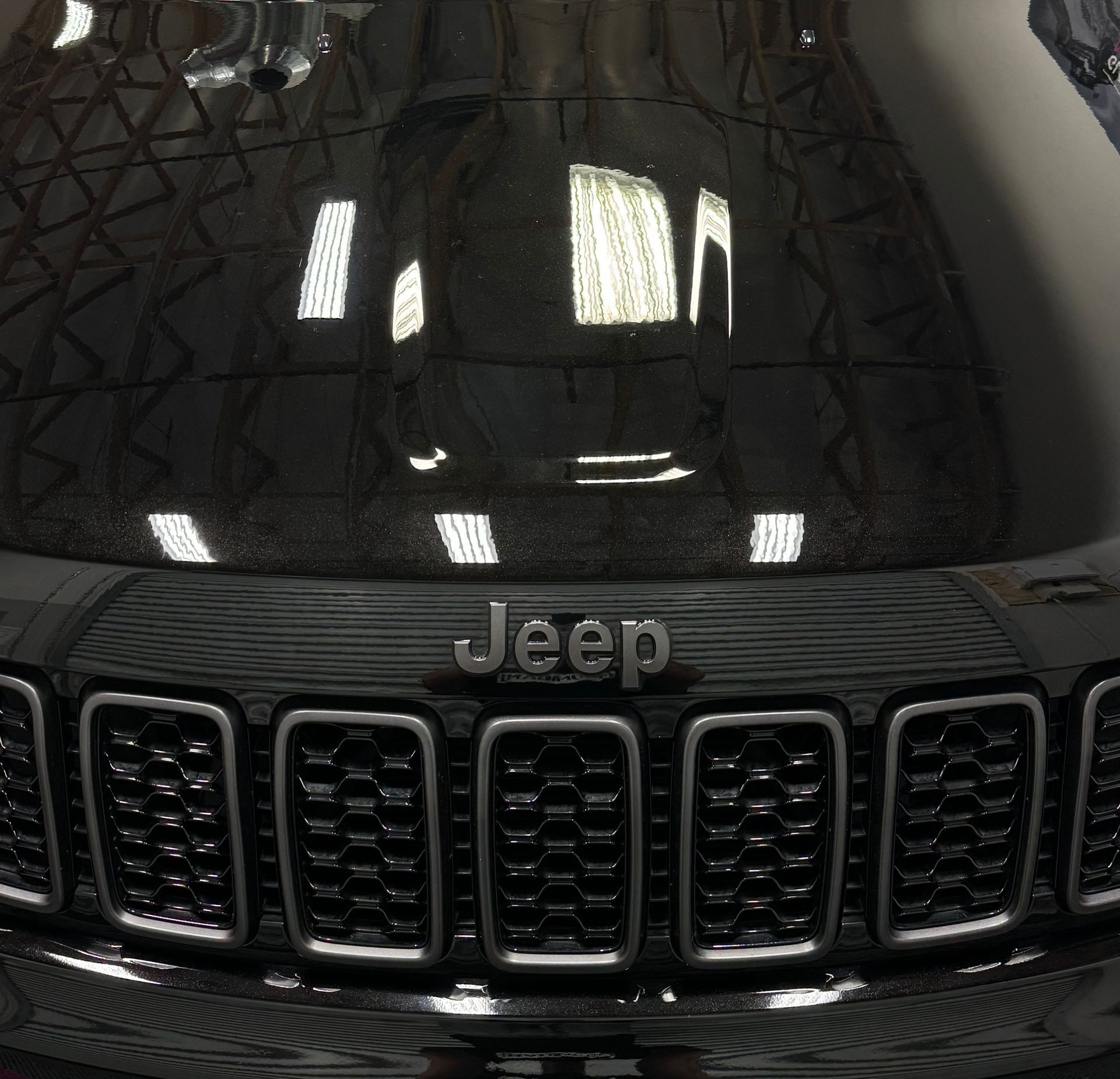 A close up of a jeep hood and grill
