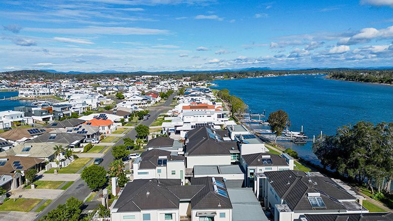 An Aerial View Of A Residential Area Next To A Body Of Water — DCK Concreting In Port Macquarie, NSW