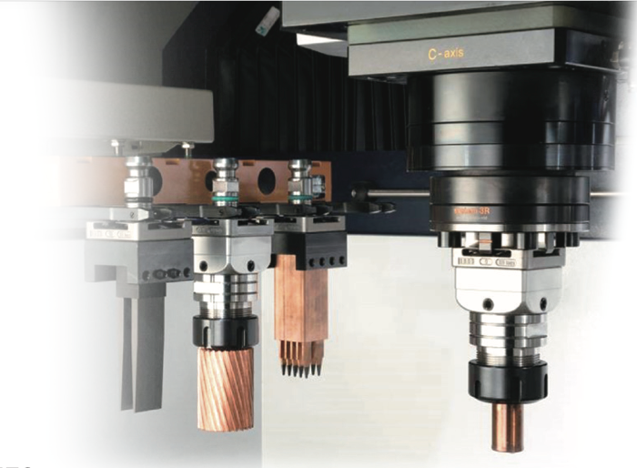 Una máquina CNC industrial con un cambiador de herramientas que sujeta electrodos de cobre y metal junto a un husillo activo.