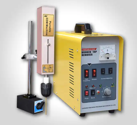 Una máquina portátil industrial amarilla para extraer machos de roscar rotos, con base magnética, panel de control 