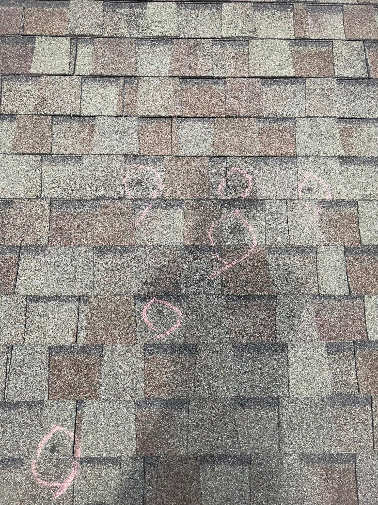 Shingled roof with a dark weather stain near the center