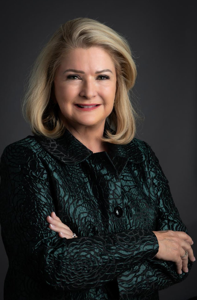 A woman is wearing a red and black polka dot jacket.