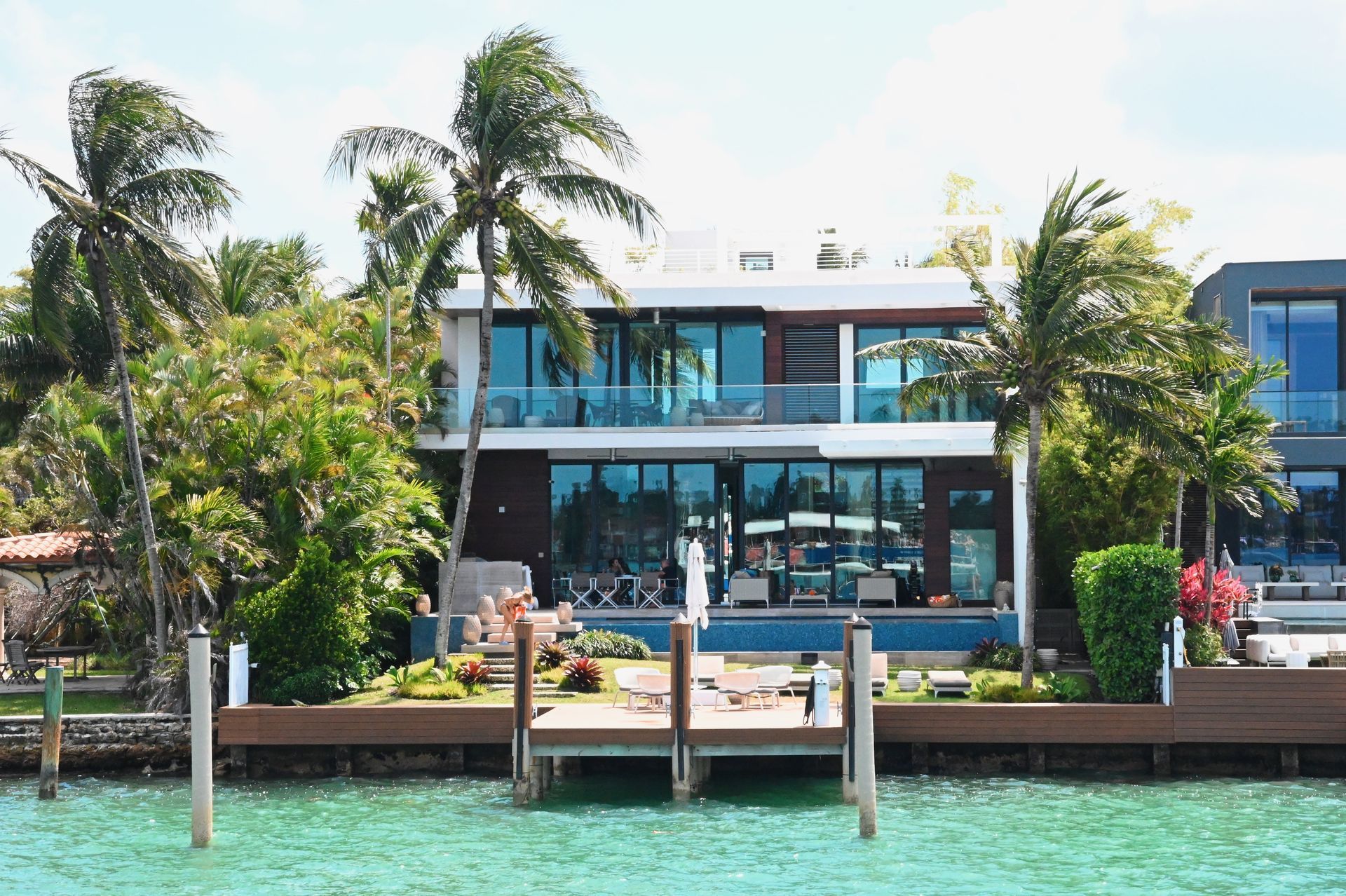Modern waterfront celebrity home seen from the boat during a Biscayne Bay celebrity homes tour