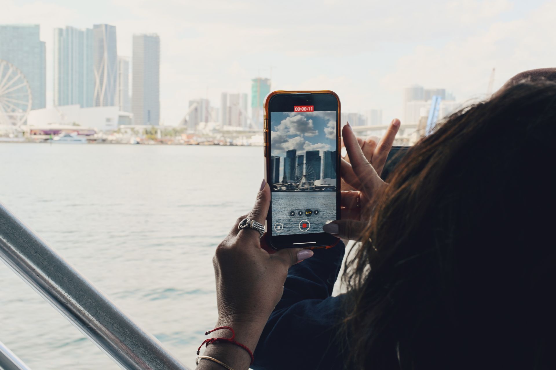 Passenger taking photos of the Miami Skyline taking advantage of the Celebrity Mansions Deal with a guarantied reservation.