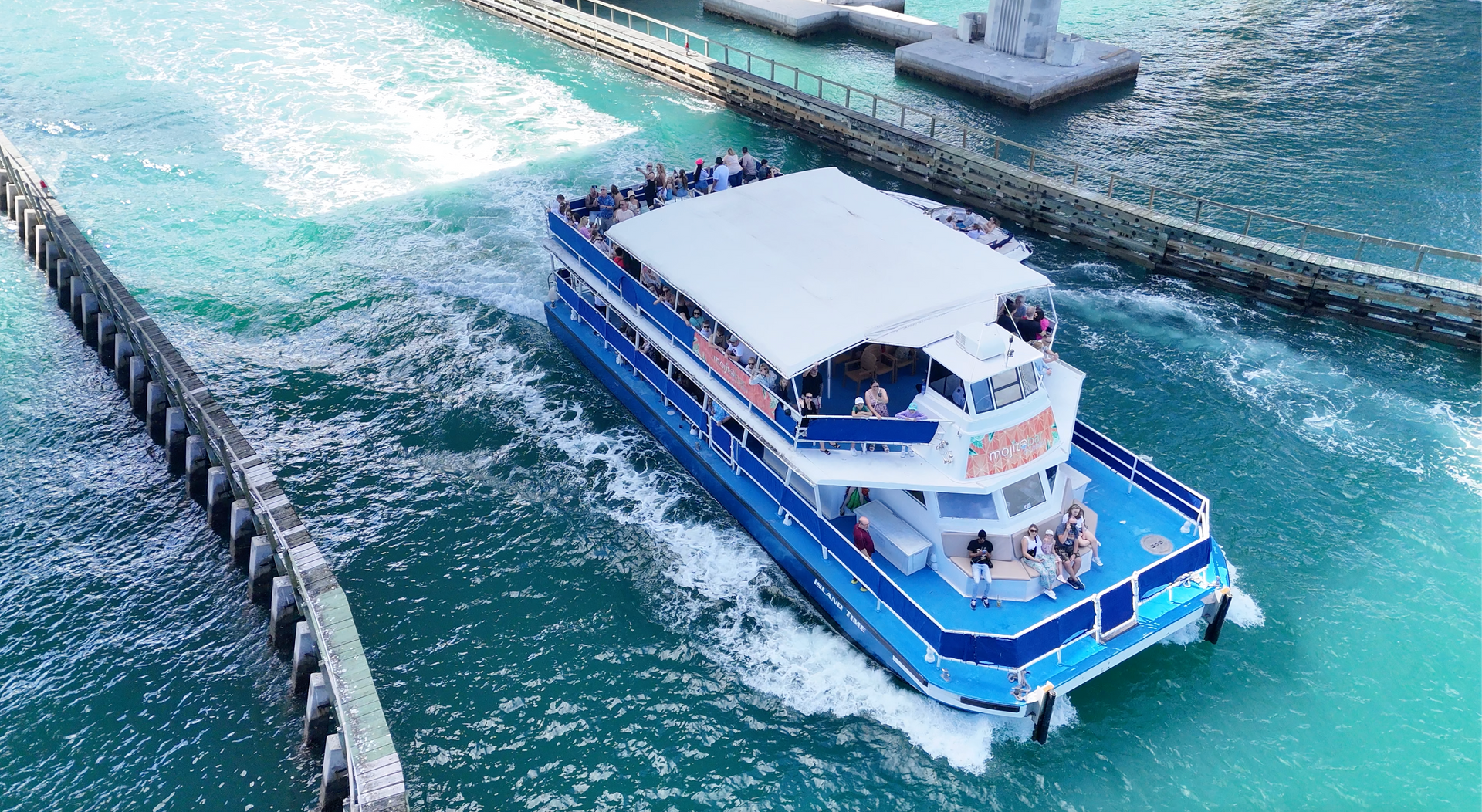 Close-up of Island Time boat with Mojito Bar onboard during a Miami celebrity mansion cruise