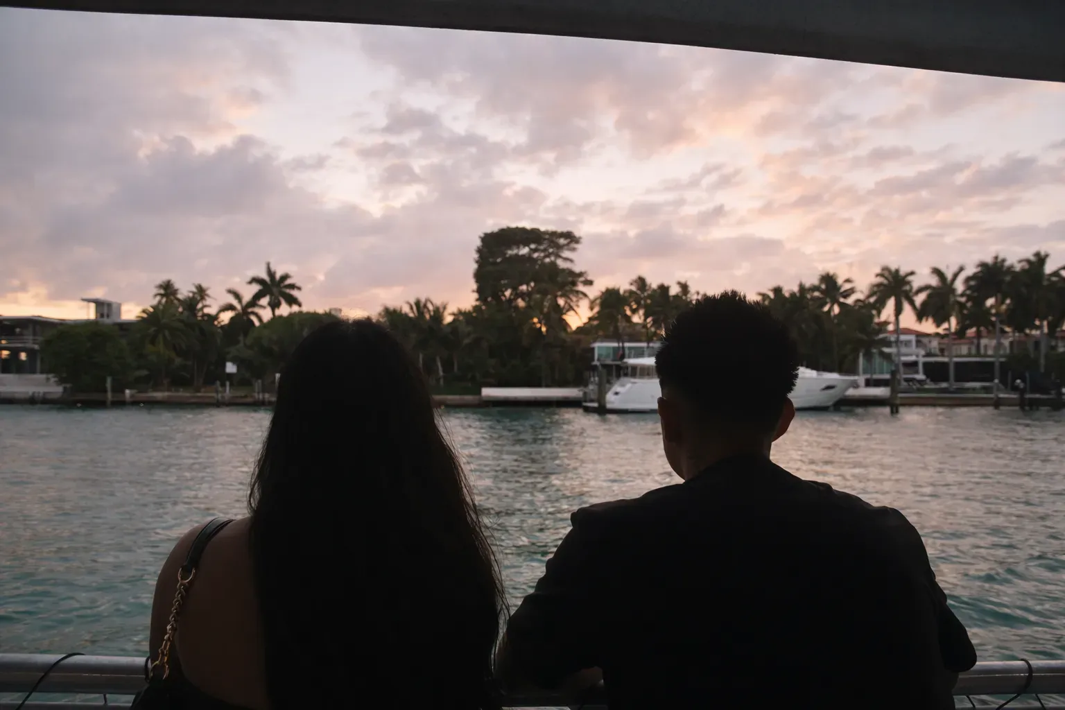 Couple enjoying a Miami Sunset Cruise with waterfront mansion views on Biscayne Bay.
