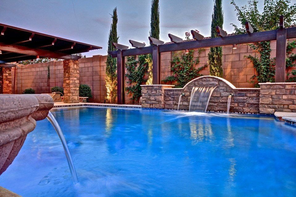 There is a waterfall in the middle of the pool.