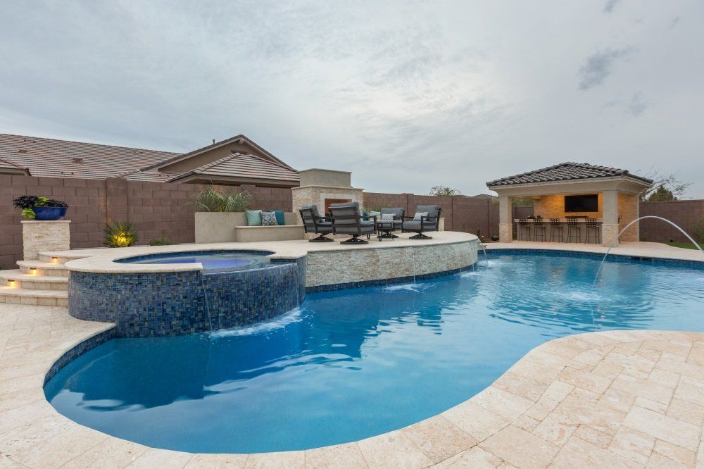A large swimming pool with a gazebo in the background