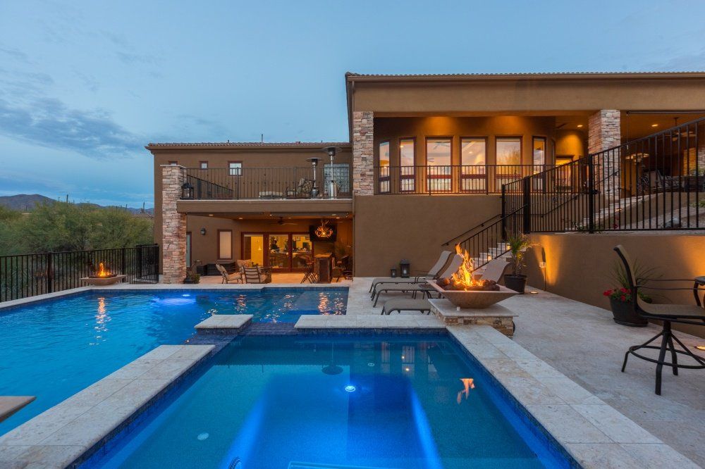 A large house with a large swimming pool in front of it.