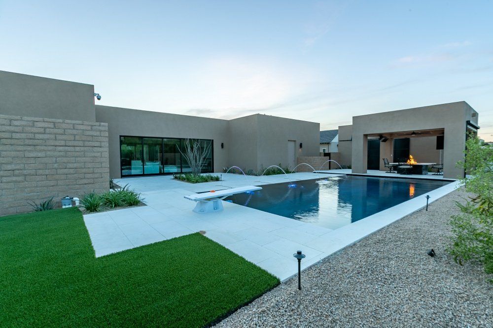 A large house with a swimming pool in the backyard.