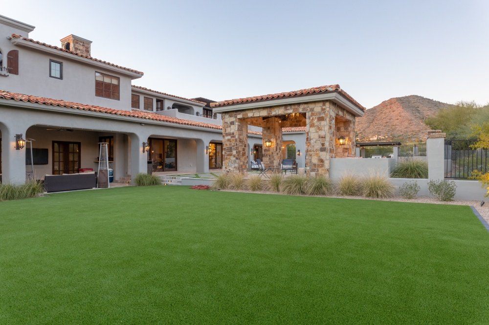 A large house with a large lawn in front of it.