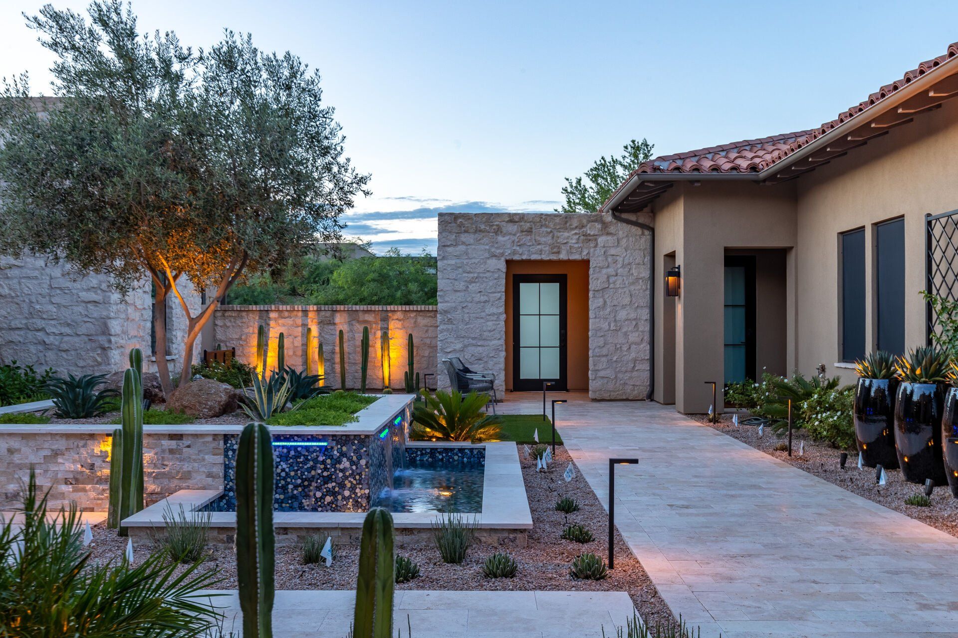 A large house with a pool in the backyard and a walkway leading to it.