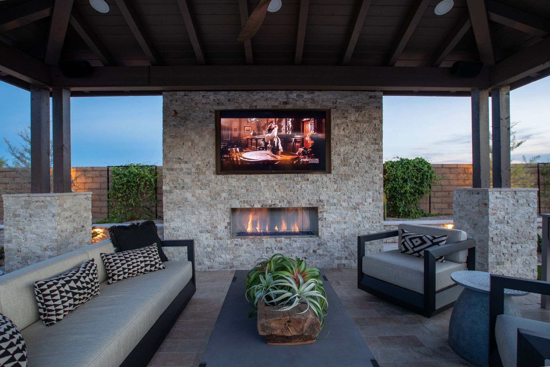 A living room with a fireplace and a flat screen tv on the wall.