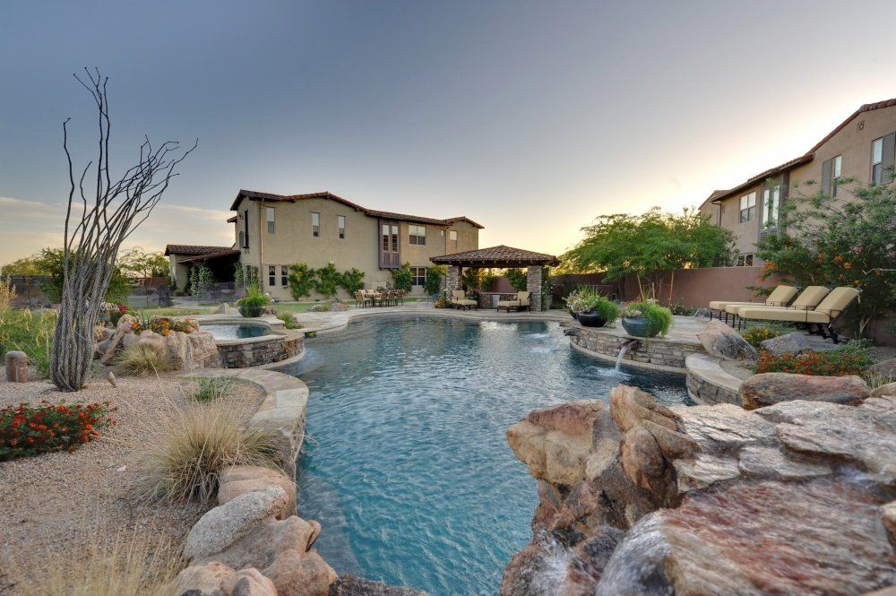 A large swimming pool in the backyard of a house