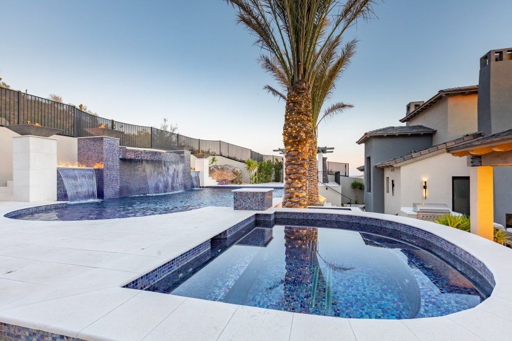 A large swimming pool with a palm tree in the middle of it.