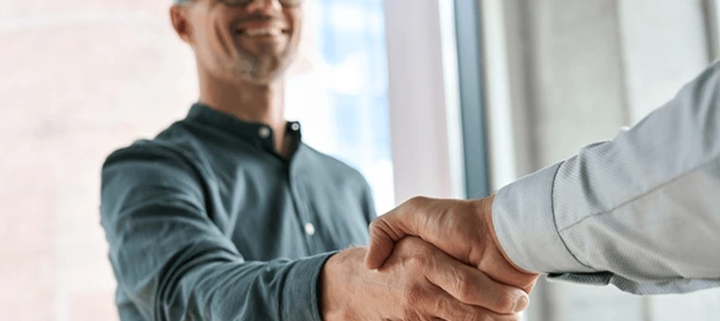 Image of two people shaking hands