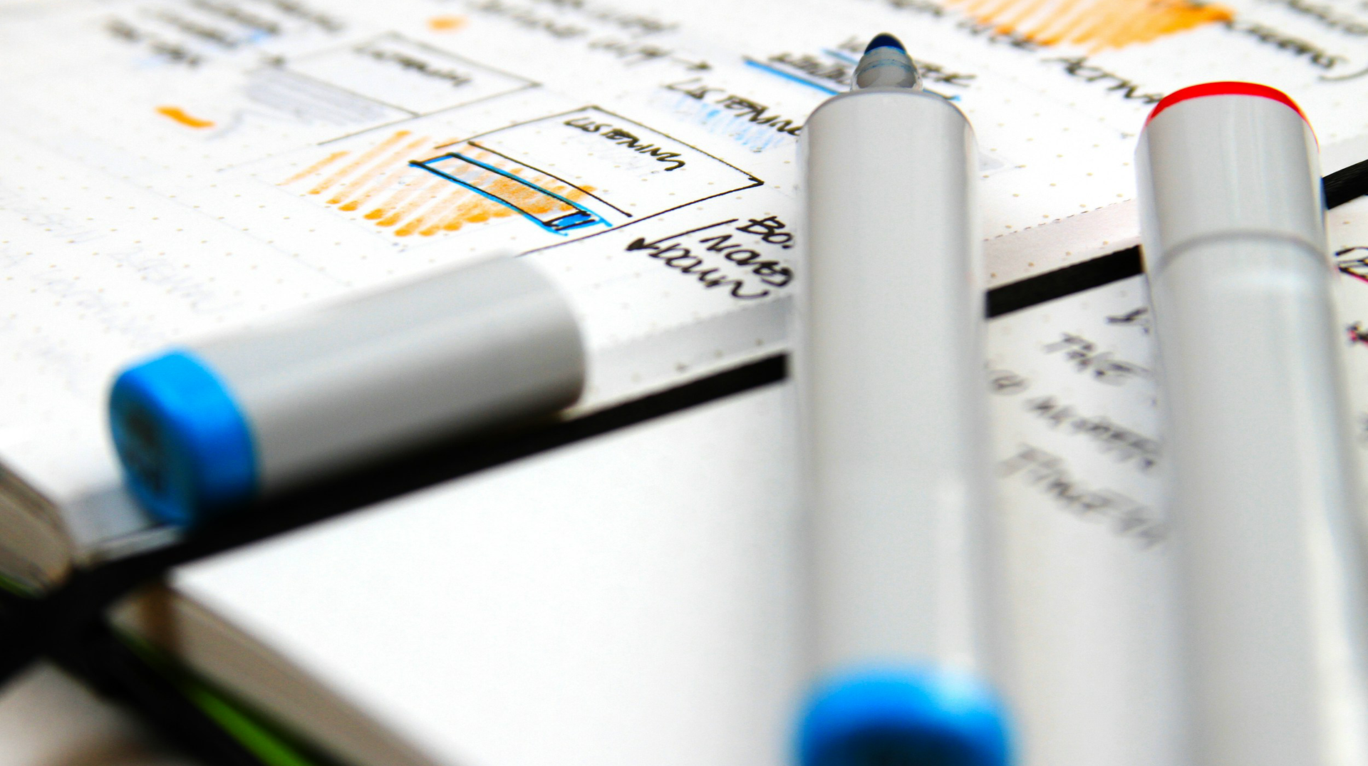 Image of two pens laying on an open book