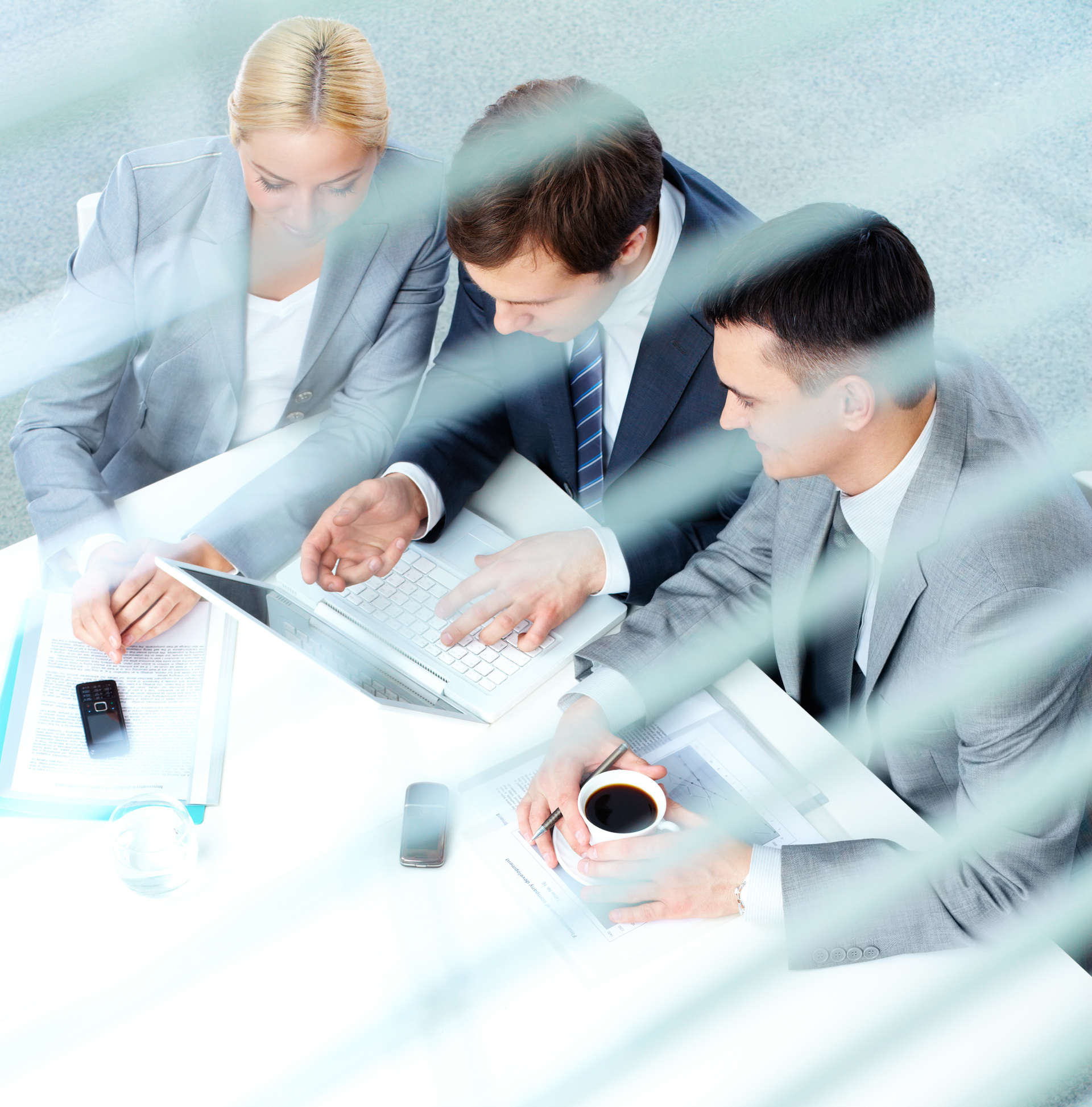 Image of co-workers sitting at a desk