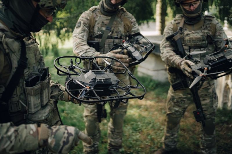 Image of soldiers holding a drone