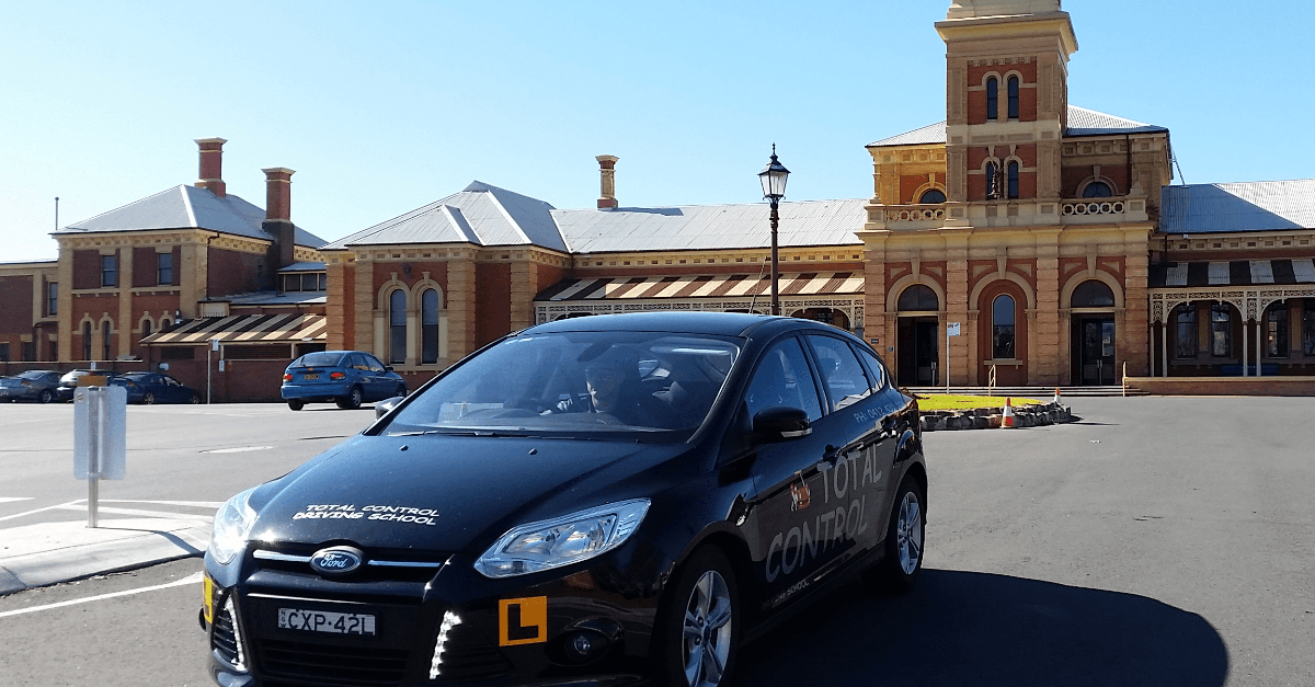 Total Control Driving Schoo's Black Vehicle at Albury Train Station