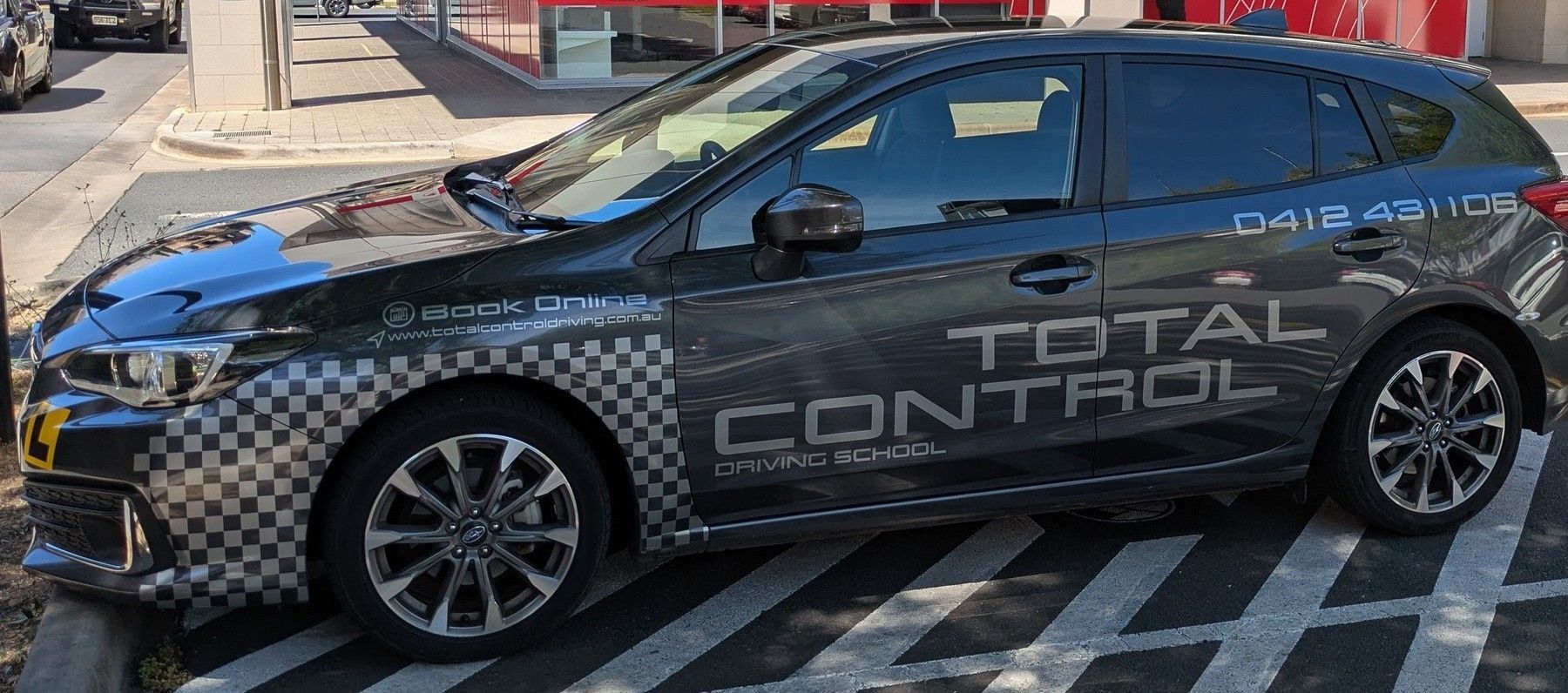 Total Control Driving School's Black Vehicle