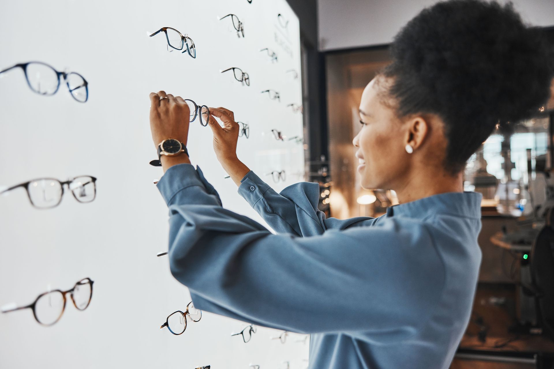 woman viewing eyeglasses on display