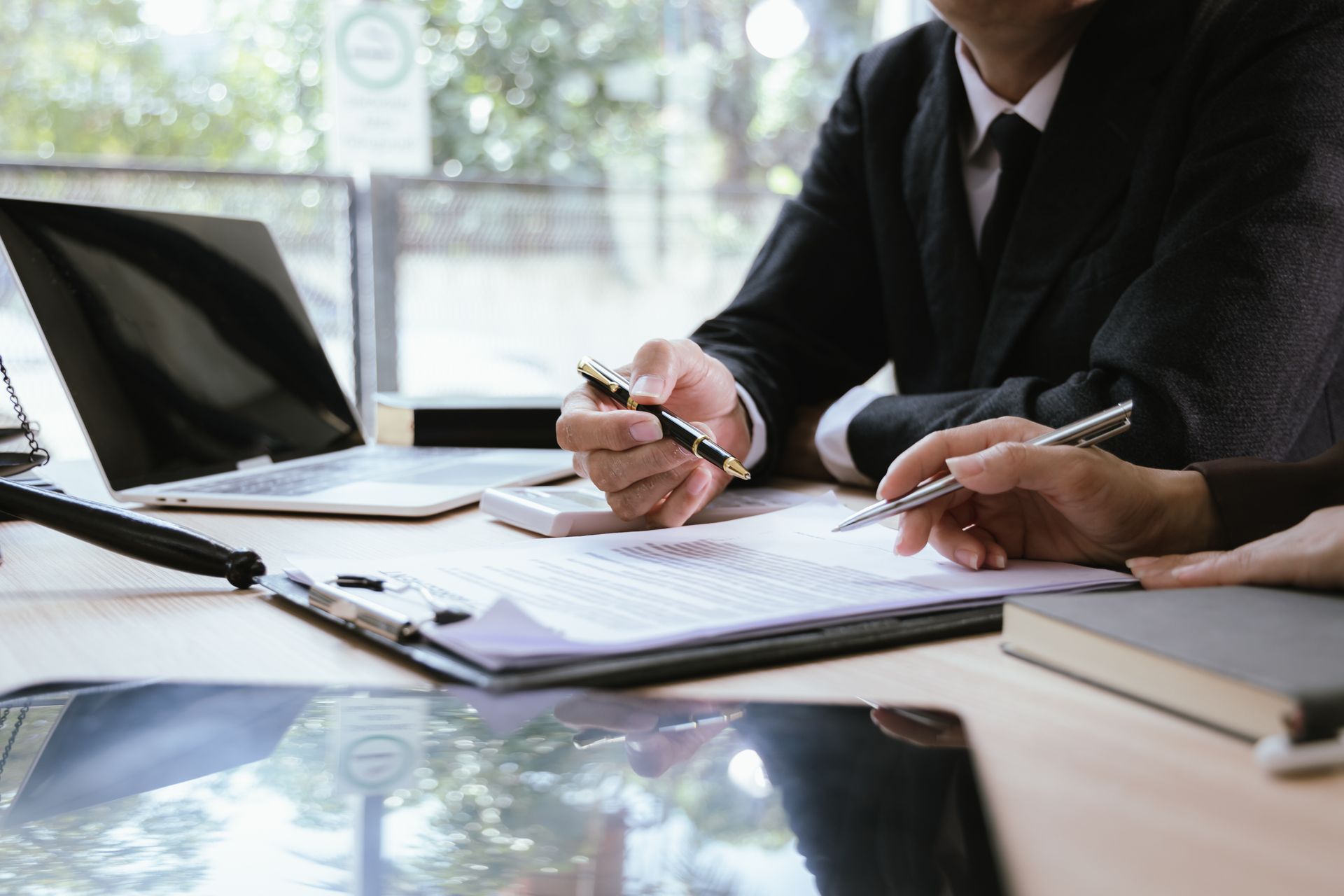 Personal injury lawyer reviewing documents with a client during a consultation Personal injury lawyer reviewing documents with a client during a consultation
